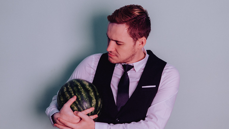 A man and a watermelon / Boy in classic suit with a watermelonの写真素材