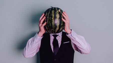 A man and a watermelon / Boy in classic suit with a watermelonの写真素材