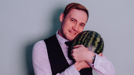 A man and a watermelon / Boy in classic suit with a watermelonの写真素材