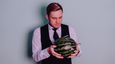 A man and a watermelon / Boy in classic suit with a watermelonの写真素材