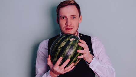 A man and a watermelon / Boy in classic suit with a watermelonの写真素材