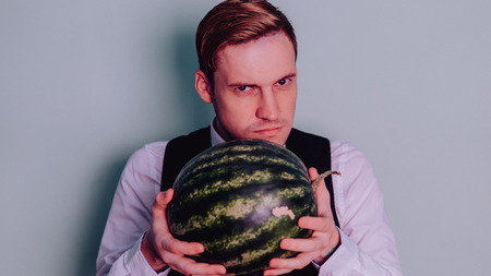 A man and a watermelon / Boy in classic suit with a watermelonの写真素材