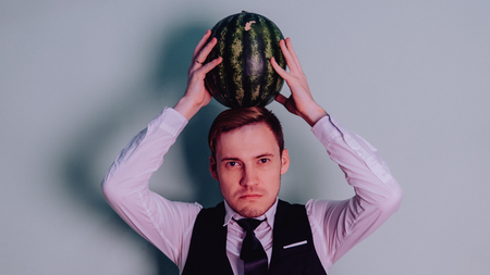 A man and a watermelon / Boy in classic suit with a watermelonの写真素材