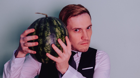 A man and a watermelon / Boy in classic suit with a watermelonの写真素材