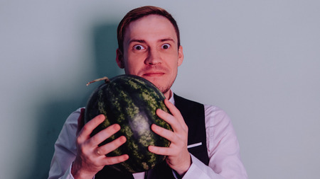 A man and a watermelon / Boy in classic suit with a watermelonの写真素材