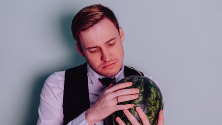 A man and a watermelon / Boy in classic suit with a watermelonの写真素材