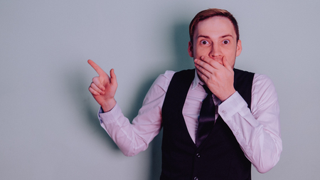 Happy attractive guy in classic suit with tie, very surprised. Man in shockの写真素材