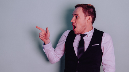 Happy attractive guy in classic suit with tie, very surprised. Man in shockの写真素材