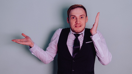 Happy attractive guy in classic suit with tie, very surprised. Man in shockの写真素材