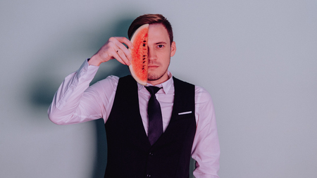 A man and a watermelon / Boy in classic suit with a watermelonの写真素材