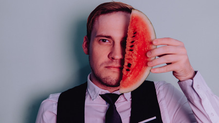 A man and a watermelon / Boy in classic suit with a watermelon