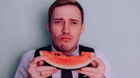 A man and a watermelon / Boy in classic suit with a watermelon