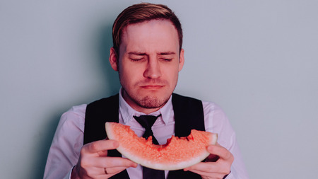 A man and a watermelon / Boy in classic suit with a watermelonの写真素材
