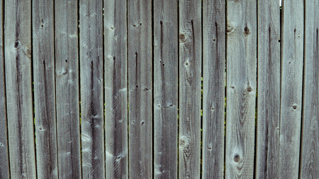 Multicolored wooden wall and blue sky. A colored wall of wood with a lot of copy space. Wooden fence and blue sky. Colored Painted Old Shabby Wooden Desk Background. Wooden Background.の写真素材