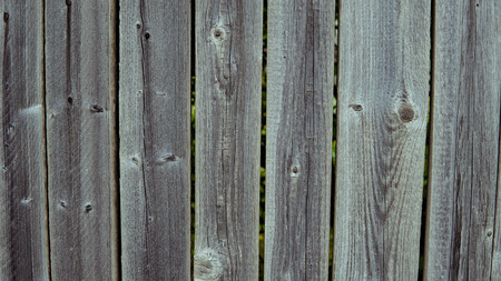 Multicolored wooden wall and blue sky. A colored wall of wood with a lot of copy space. Wooden fence and blue sky. Colored Painted Old Shabby Wooden Desk Background. Wooden Background.の写真素材