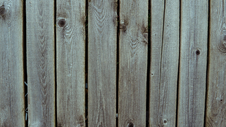 Multicolored wooden wall and blue sky. A colored wall of wood with a lot of copy space. Wooden fence and blue sky. Colored Painted Old Shabby Wooden Desk Background. Wooden Background.の写真素材
