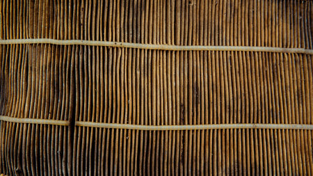 Texture of diagonal stripes with a shadow, with triangular curved ribs, edges of light white fabric, paper with triangular strips and small holes, pores. The background.の写真素材