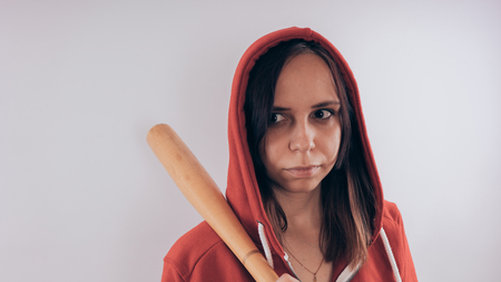 Girl with a bat. girl in the background. Body art. Sport and trainingの写真素材