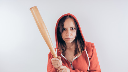Girl with a bat. girl in the background. Body art. Sport and trainingの写真素材