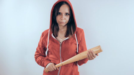 Girl with a bat. girl in the background. Body art. Sport and trainingの写真素材