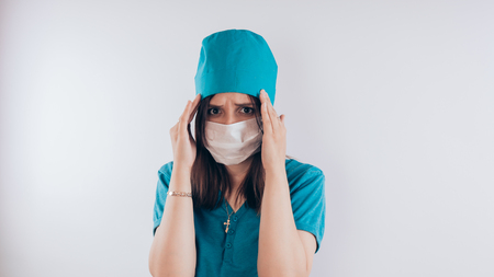 Portrait of a friendly smiling doctor woman or nurse in white medical uniform with a syringe, isolated on white background with copy space. Healthcare and medicine conceptの写真素材