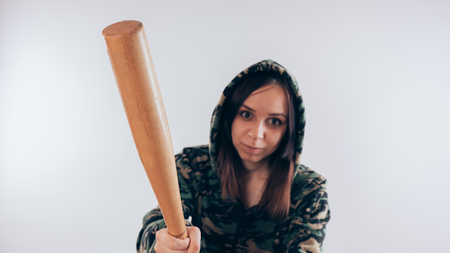Girl with a bat. girl in the background. Body art. Sport and trainingの写真素材