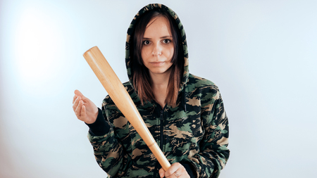 Girl with a bat. girl in the background. Body art. Sport and trainingの写真素材