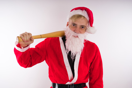 Santa Claus with a baseball bat, the concept of an evil Santa Claus for Christmasの写真素材