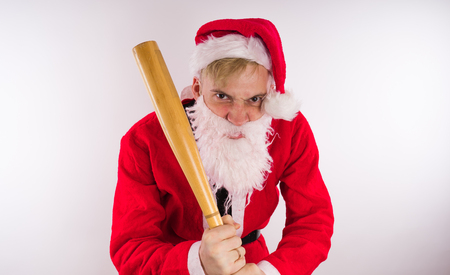 Santa Claus with a baseball bat, the concept of an evil Santa Claus for Christmasの写真素材