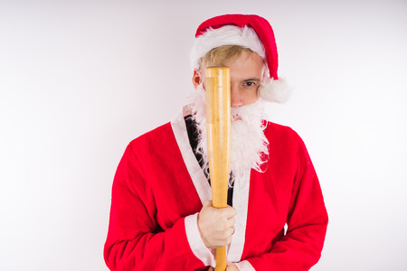 Santa Claus with a baseball bat, the concept of an evil Santa Claus for Christmasの写真素材