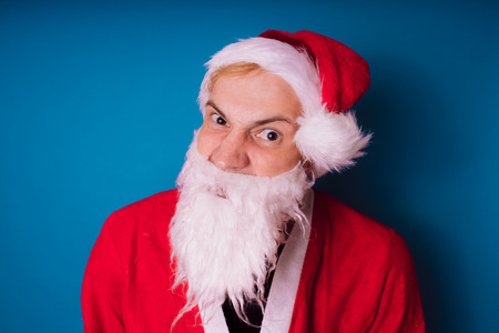 Santa Claus on a blue background. Happy New Year and merry Christmas!の写真素材