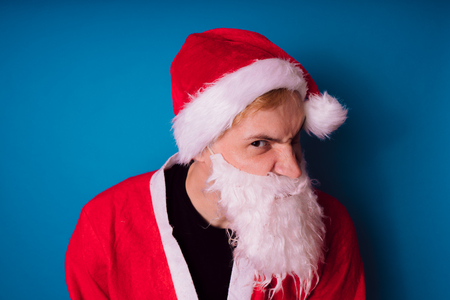 Santa Claus on a blue background. Happy New Year and merry Christmas!の写真素材
