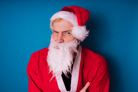 Santa Claus on a blue background. Happy New Year and merry Christmas!の写真素材