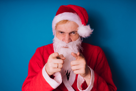 Santa Claus on a blue background. Happy New Year and merry Christmas!の写真素材