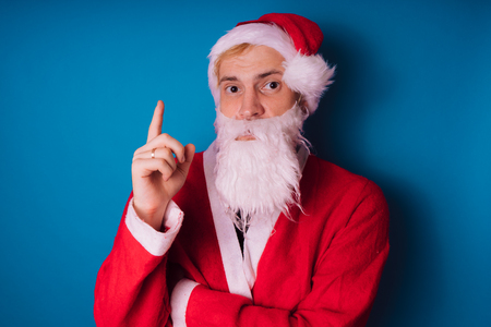 Santa Claus on a blue background. Happy New Year and merry Christmas!の写真素材