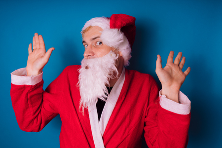 Santa Claus on a blue background. Happy New Year and merry Christmas!の写真素材