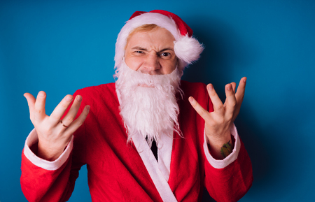 Santa Claus on a blue background. Happy New Year and merry Christmas!の写真素材