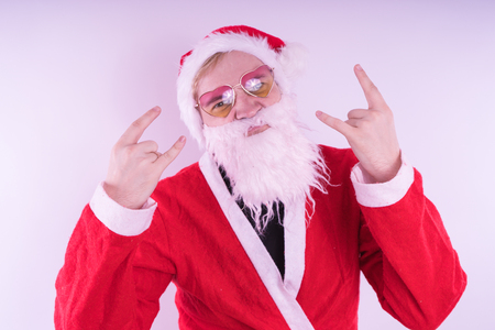 Emotional Santa Claus with glasses on blue background. Happy New Year and merry Christmas!の写真素材