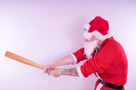 Emotional Santa Claus with a tattoo of a bat on a white background. The concept of an evil Santa Claus. Happy New Year and merry Christmas!の写真素材