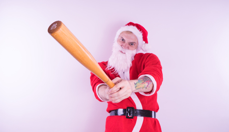 Emotional Santa Claus with a tattoo of a bat on a white background. The concept of an evil Santa Claus. Happy New Year and merry Christmas!の写真素材
