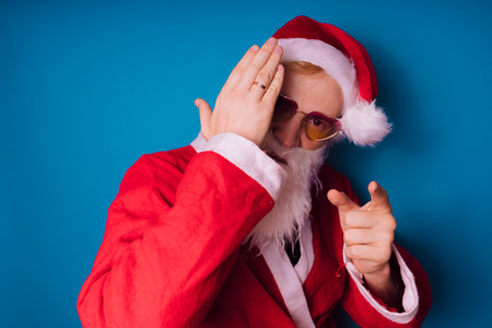 Emotional Santa Claus with glasses on white background. Happy New Year and merry Christmas!の写真素材
