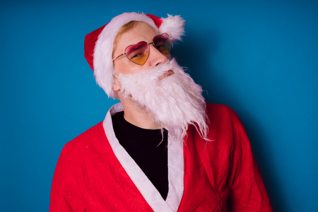 Emotional Santa Claus with glasses on white background. Happy New Year and merry Christmas!の写真素材