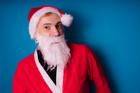 Santa Claus on a blue background. Happy New Year and merry Christmas!の写真素材
