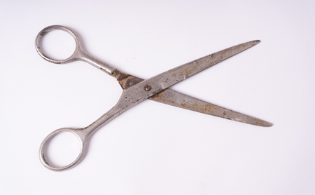 Old scissors lie isolated on white backgroundの写真素材