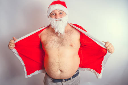 Thick emotional Santa Claus on plowing with bare torsoの写真素材