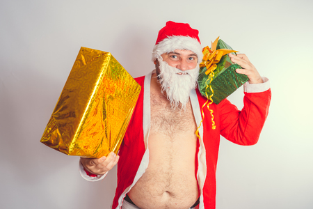 Thick emotional Santa Claus on plowing with bare torsoの写真素材