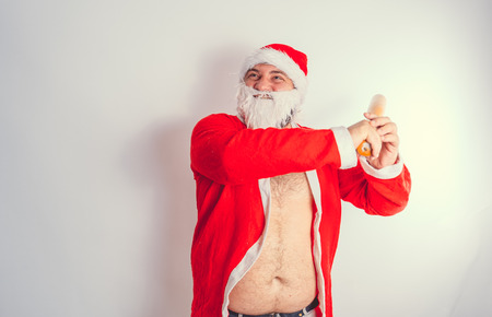 Thick emotional Santa Claus on plowing with bare torsoの写真素材