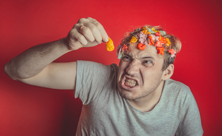 Gum in his head. Portrait of a man with chewing gum in his head. Man with hair covered in food. Hen red hairの写真素材