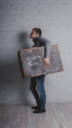 The guy with the suitcase, vacation package. Huge suitcase. Concept: vacation and vacation.の写真素材