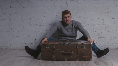 The guy with the suitcase, vacation package. Huge suitcase. Concept: vacation and vacation.の写真素材